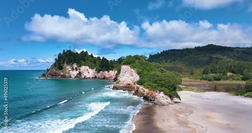 Flight traverses close-up of Whiritoa lagoon, beach, and beautiful headland photo