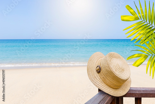 Hat on wooden fence over summer beach background  outdoor day light  summer holiday