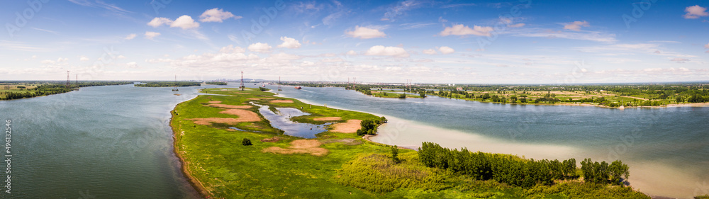 Panoramic aerial view of Varennes islands and the St. Lawrence Seaway with Montreal in background.