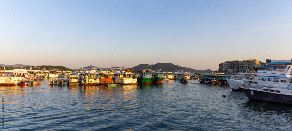 various Junks park at harbor in Sai Kung, Hong Kong, a typhoon shelter, where junks used in the local tourist trade now are moored. also famous for sea food