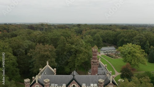 Drone flying backwards and reveal Schaffelaar Castle in Barneveld, the Netherlands photo