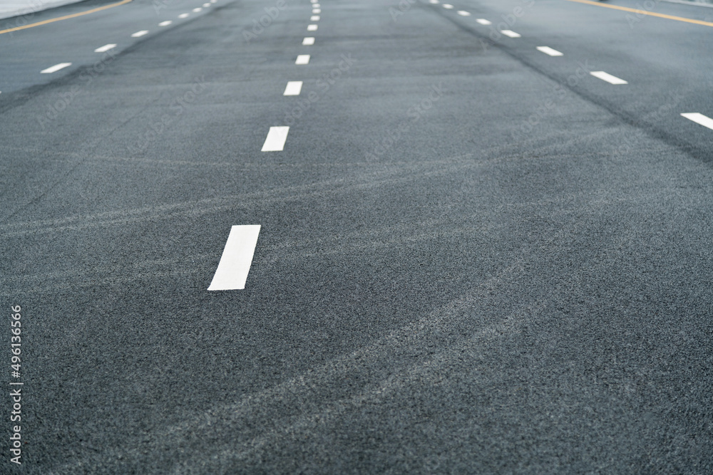 Asphalt road with white dashed lines Asphalt road with white dashed lines