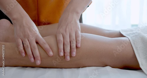 Masseuse  hands doing legs massage of female  in spa massage room.Woman came to massage therapy due to body aches.spa treatments.Slow motion.Healthy lifestyle and body concept.