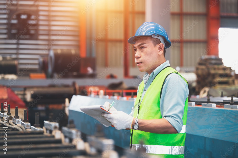 Fototapeta premium Asian engineer working control machine in factory.