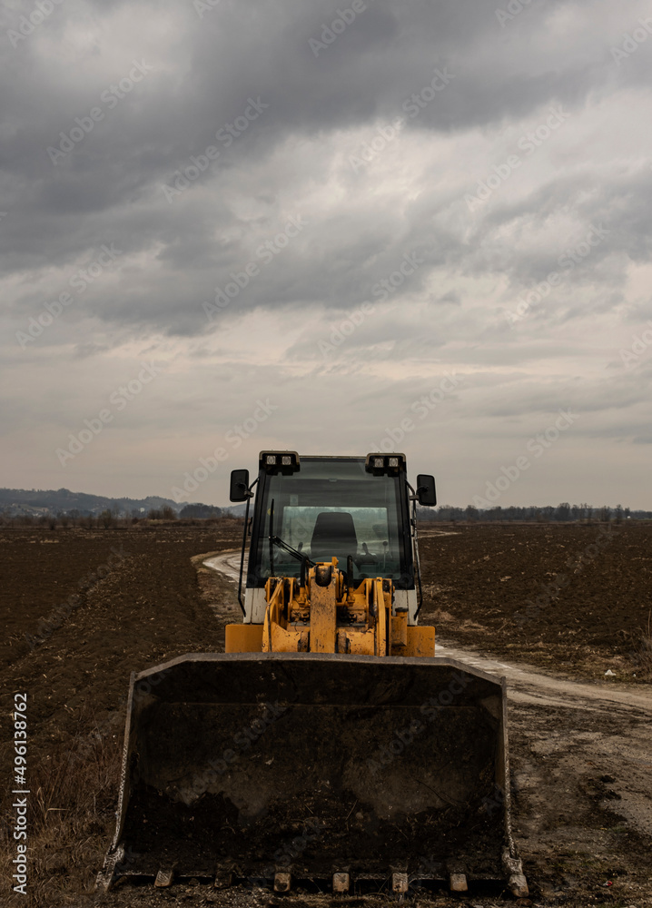 Fototapeta premium bulldozer on construction site, cloudy day, no driver