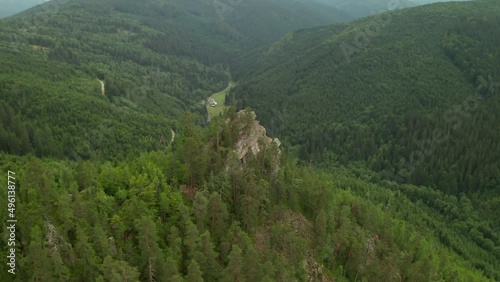 Aerial 4K drone orbit and descending footage close to the top of a hill with a Christian cross near Osrblie, Central Slovakia, Europe. Environment, trekking, landscapes concept. photo