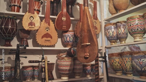 Antique instruments with colorful patterns in Moroccan market store, handheld view