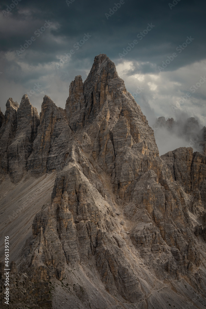Paternkofel mountains in the Dolomite Alps in South Tyrol during summer with dark clouds in sky, Italy.