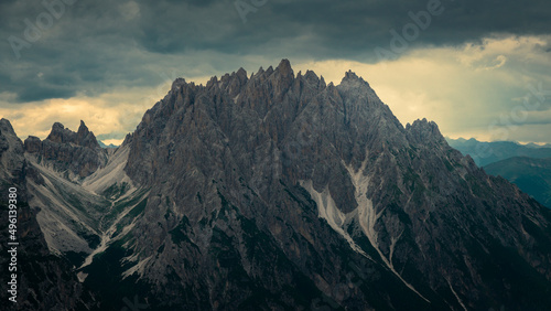 Haunold mountain chain with storm clouds during sunset at Three Peaks Hut in the Dolomite Alps in South Tyrol, Italy.