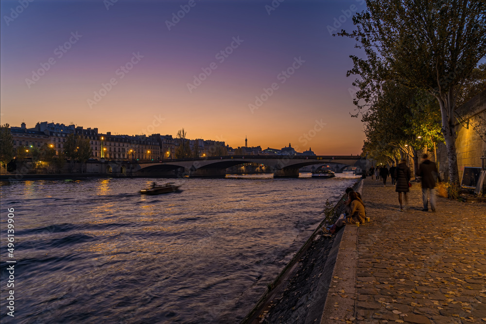 Obraz premium Boat Cruise on River in Paris at Golden Hour Sunset From Docks With Peoples and Eiffel Tower