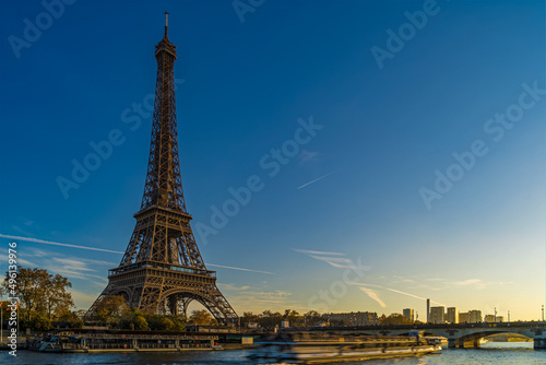 Touristic Cruise at Eiffel Tower in Paris at Golden Hour Sunset With Blue Sky