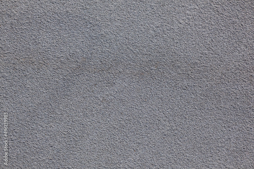 Texture of gray asphalt. Gray fine-grained wall.