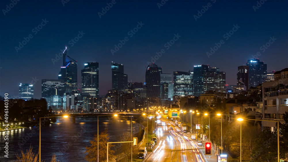 Fototapeta premium Skyline of La Defense Business District at Night With Traffic
