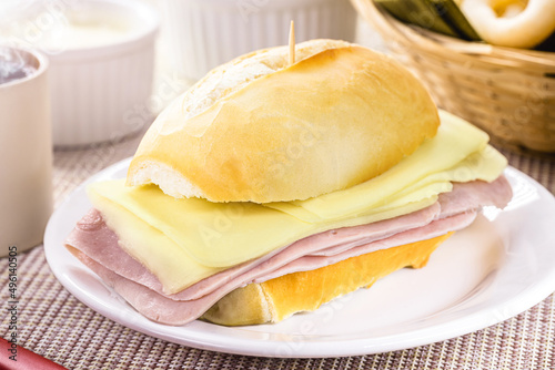 typical Brazilian snack, pão de sal with sliced ​​mozzarella cheese and ham, french bread for breakfast