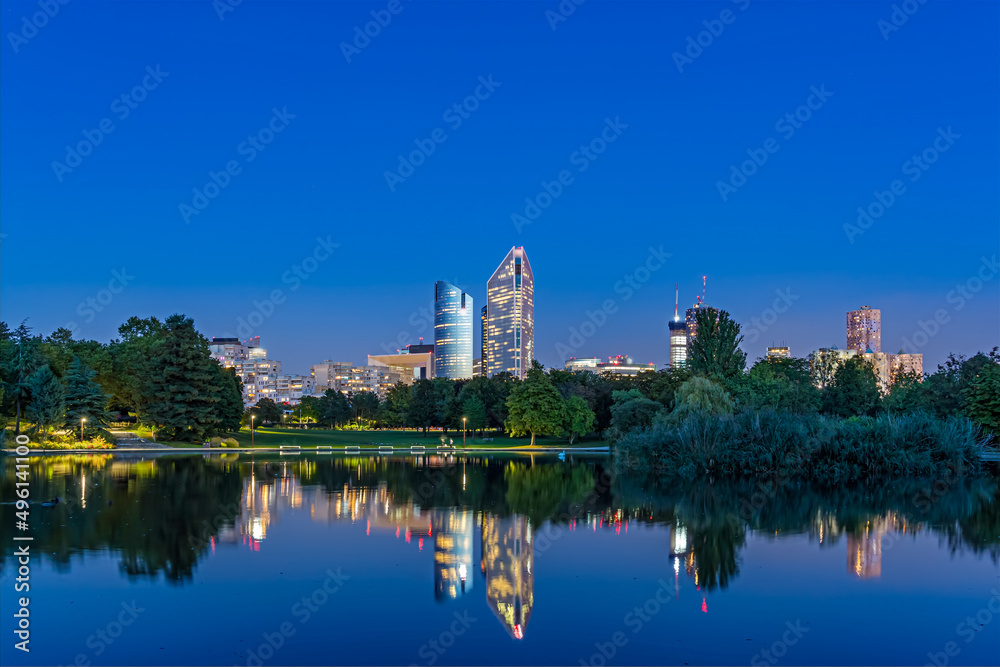 Naklejka premium Blue Hour With Enlightened Towers at La Defense District With Reflections on Lake