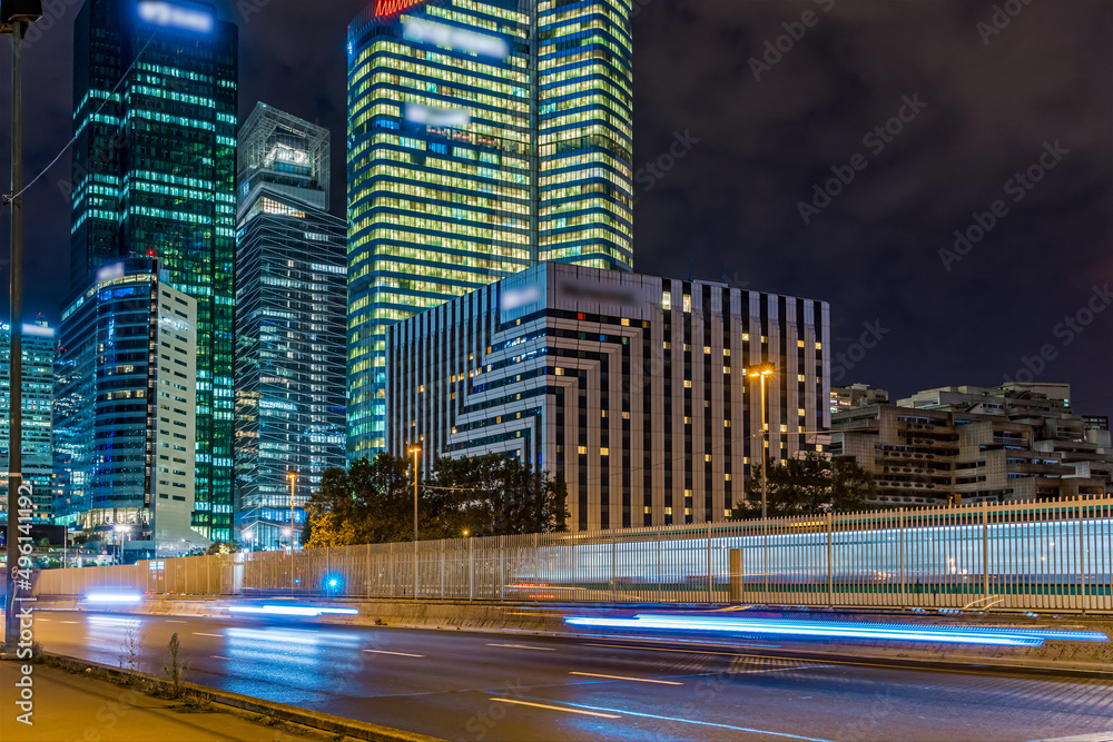 Pedestrian View of La Defense Business District at Night With Road Traffic Buildings