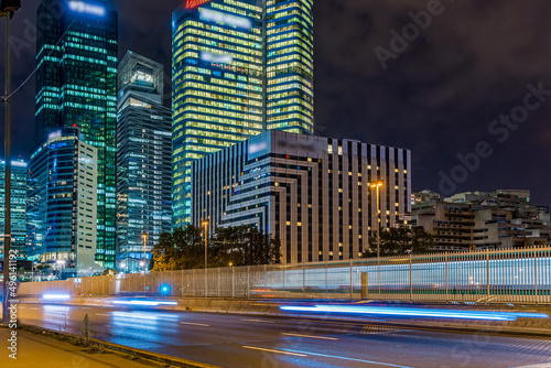Fototapeta Naklejka Na Ścianę i Meble -  Pedestrian View of La Defense Business District at Night With Road Traffic Buildings