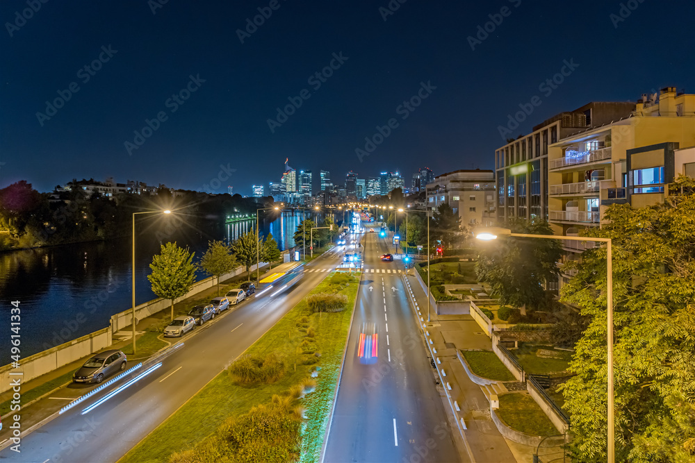 Fototapeta premium Traffic at Night Towards La Defense Business District Buildings and Seine River
