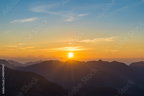 Intense Sunrise Over French Alps Mountains Peaks With Clouds