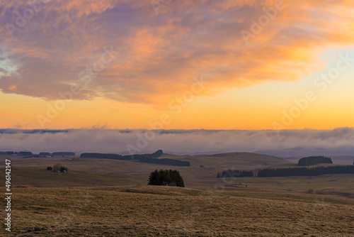 Colorful Sunrise Over Lowlands With Mist Moving Fast and Cloudy Orange Sky