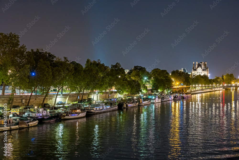 Fototapeta premium Night Traffic at Paris Famous Monuments Seine River Boats Docks and Bridge
