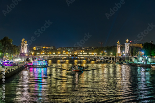 Paris Center at Night with Boats Traffic Over Seine River Bridges and Docks