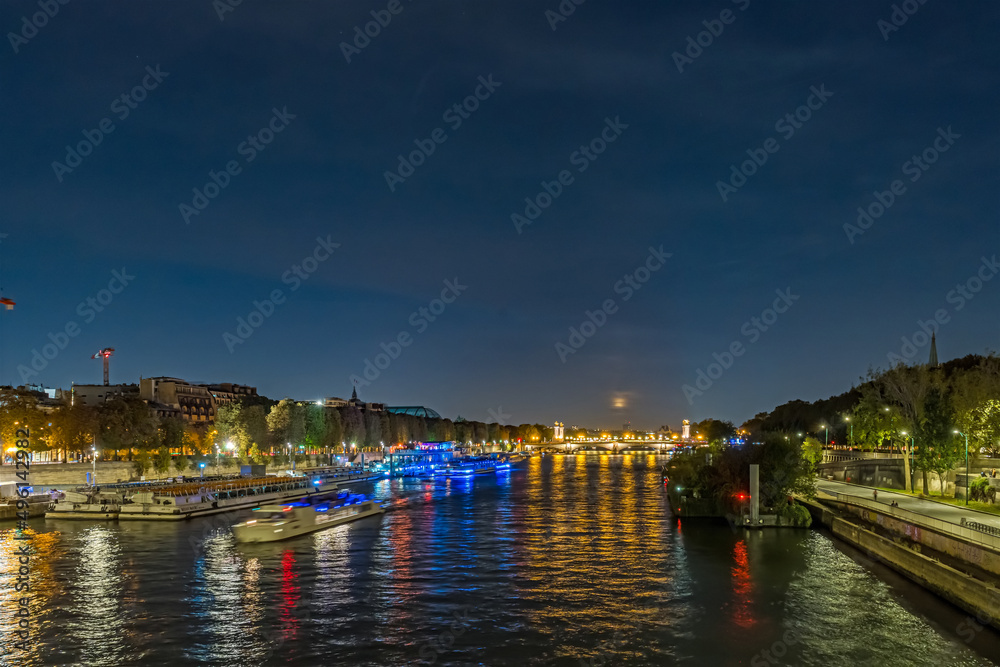 Full Moon Over Seine River in Paris at Night With Boats Cruises and Tourists