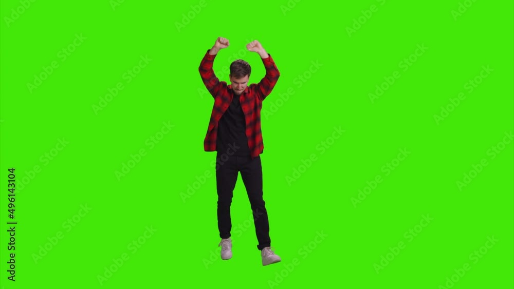 A boy is jumping and dancing with his hands raised on greenscreen A boy is jumping and dancing with his hands raised on greenscreen