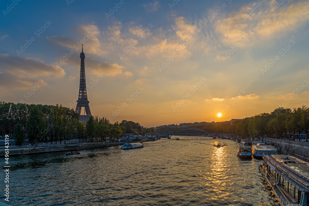 Sunset Over Eiffel Tower in Paris Seine River and Boats Cruises Trees and Clouds