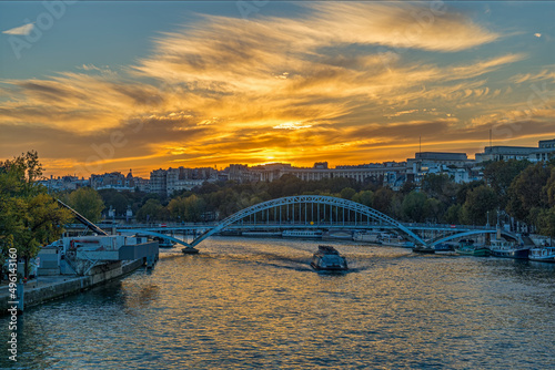 Colorful Clouds During Sunset Over Paris Seine River and Boats Cruises