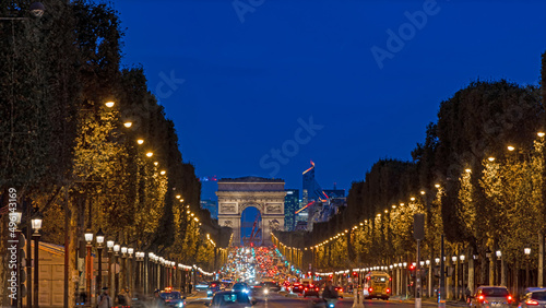 Champs-Elysees Avenue in Paris at Night With La Defense Business District in Background