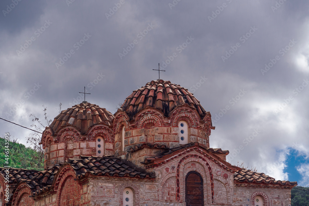 Greek Orthodox Holy Apostles Medieval Church exterior with cross above dome.