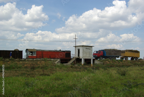 The sugar cane is transported by truck and will then be lloaded on the train