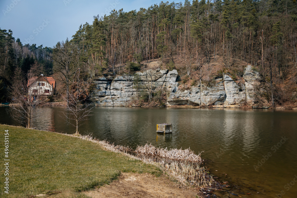 Vysoka Bosyne, Czech Republic, 19 March 2022: rock formation and protected landscape area in Kokorinsko, sandstone cliffs near beautiful lake Harasov at sunny day