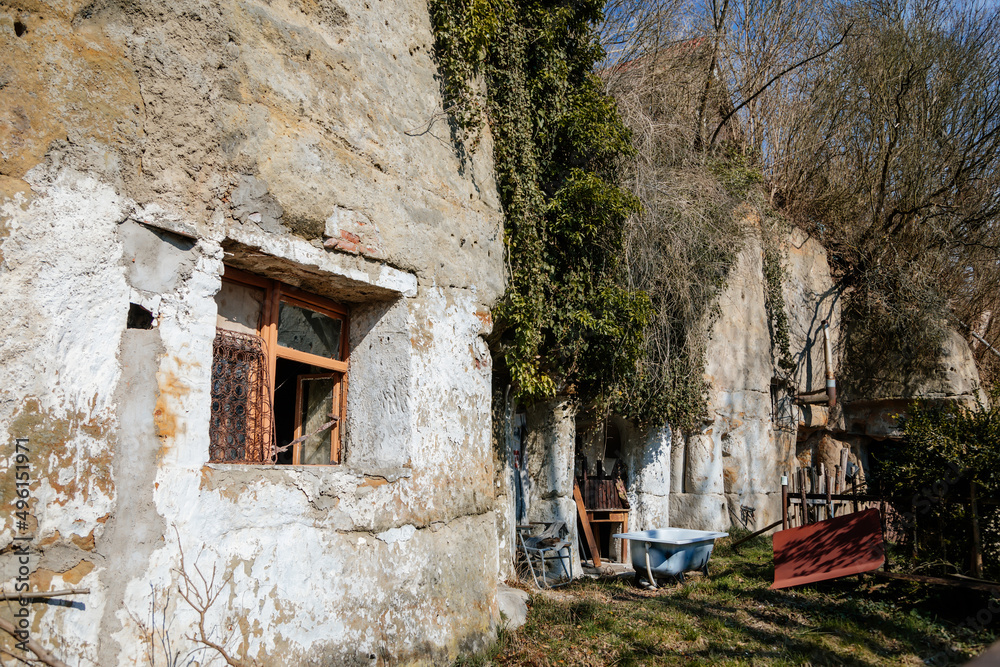 Truskavna Czech Republic, 19 March 2022: Rock apartment, abandoned house, broken open window, old bathroom, formation and protected landscape area in Kokorinsko, sandstone cliffs at sunny day