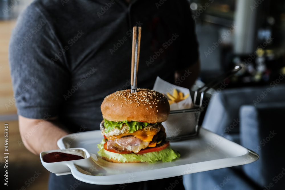 eating tasty grilled prawn and beef burger eating tasty grilled prawn and beef burger