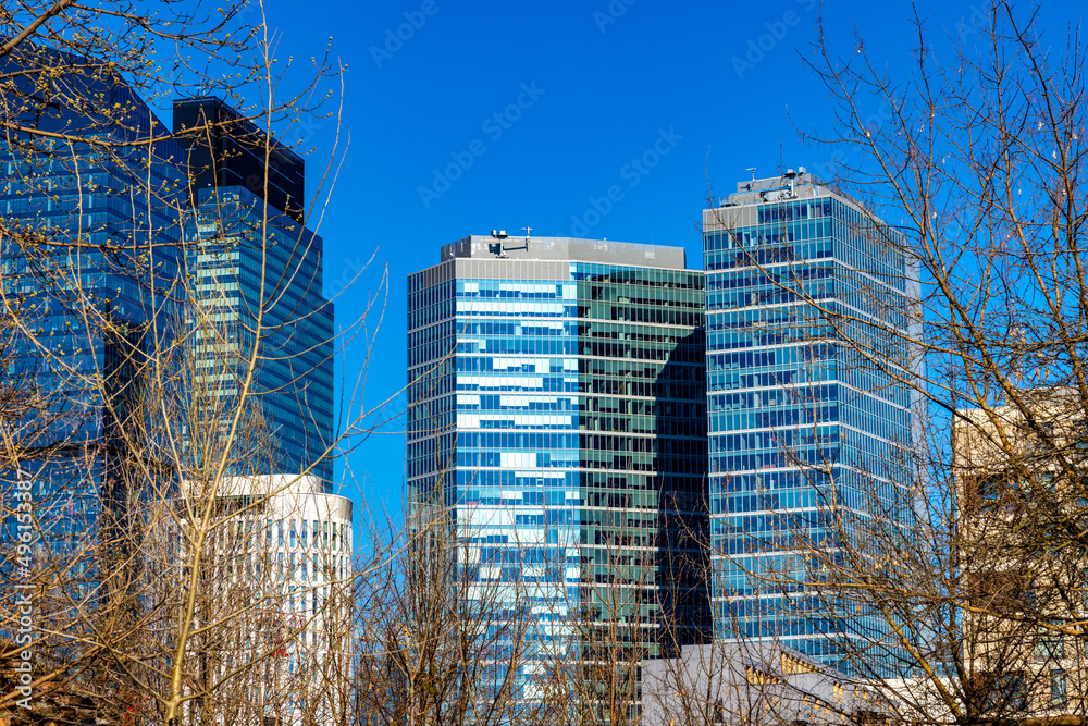 Newly developed towers of office skyscrapers over rondo Daszynskiego circle in booming Wola business district of city center in Warsaw, Poland - obrazy, fototapety, plakaty 