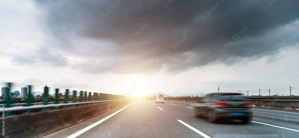Car driving on the highway under dark sky