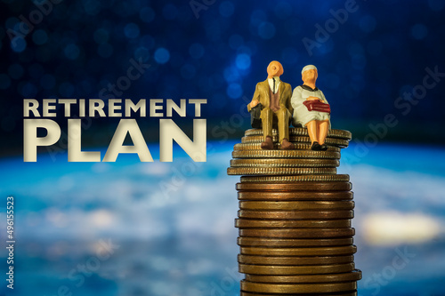 older couple miniature seating on money coins saving for investment concept mutual fund financing and retirement Macro