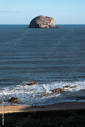 The steep cliffs tower over Canty Beach on the edge of the Firth of Forth and the Bass Rcck providing an iconic backdrop photo