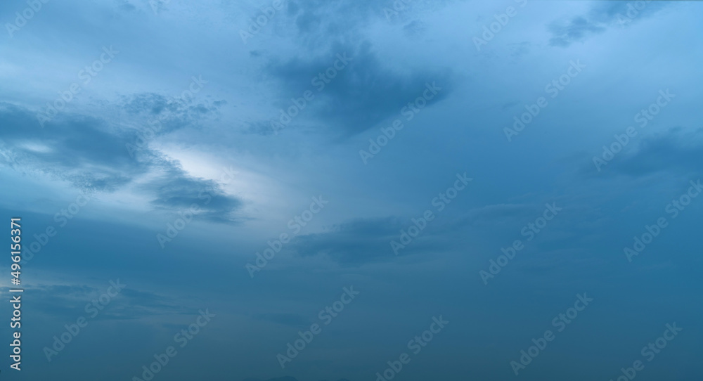 Gray clouds in dark blue sky