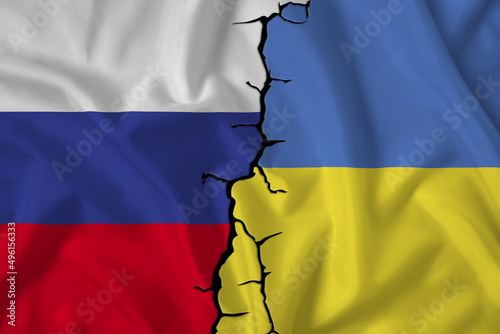 Flags of the Russian Federation and Ukraine on the background of the cracks. Crisis in relations between countries. War on the border. Political dialogue and meeting of presidents.