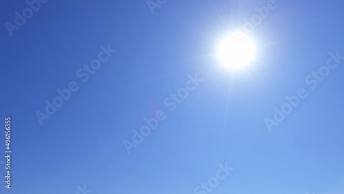 4k tropical summer sun light ray on sunny clear blue sky TimeLapse