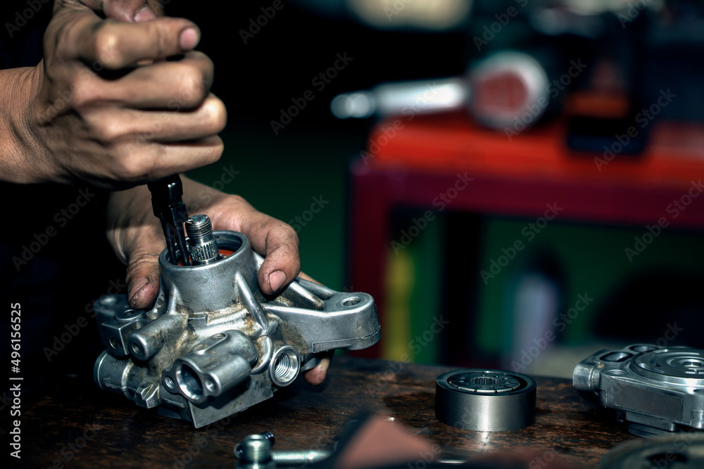 Power steering pump, mechanic repairing power pump, maintenance mechanic concept, automotive work. Power steering pump, mechanic repairing power pump, maintenance mechanic concept, automotive work.