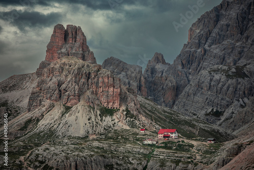 Rifugio Three Peaks Hut with Sasso di Sesto summit in the Dolomite Alps in South Tyrol with  clouds in dramatic sky during sunset, Italy. photo