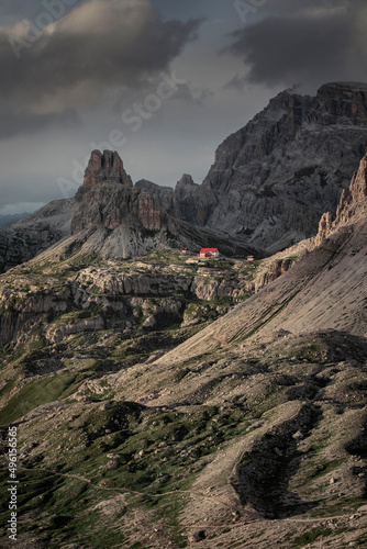 Rifugio Three Peaks Hut with Sasso di Sesto summit in the Dolomite Alps in South Tyrol with  clouds in dramatic sky during sunset, Italy. photo