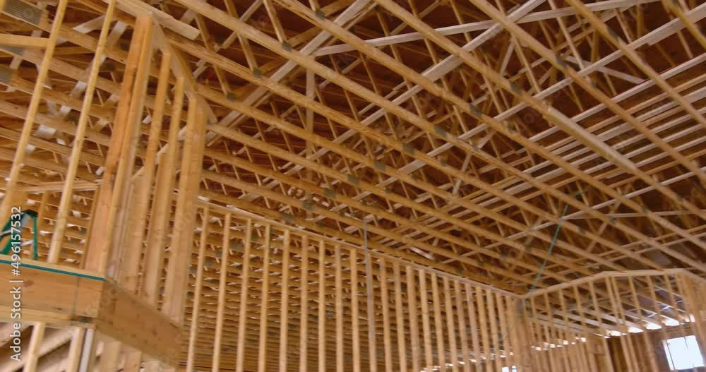 Interior view of a new home construction showing the entire timber frame wood roof trusses