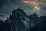 Mountain peaks in the Dolomite Alps in South Tyrol with dramatic cloudy sky during sunset, Three Peaks Nature Reserve, Italy.