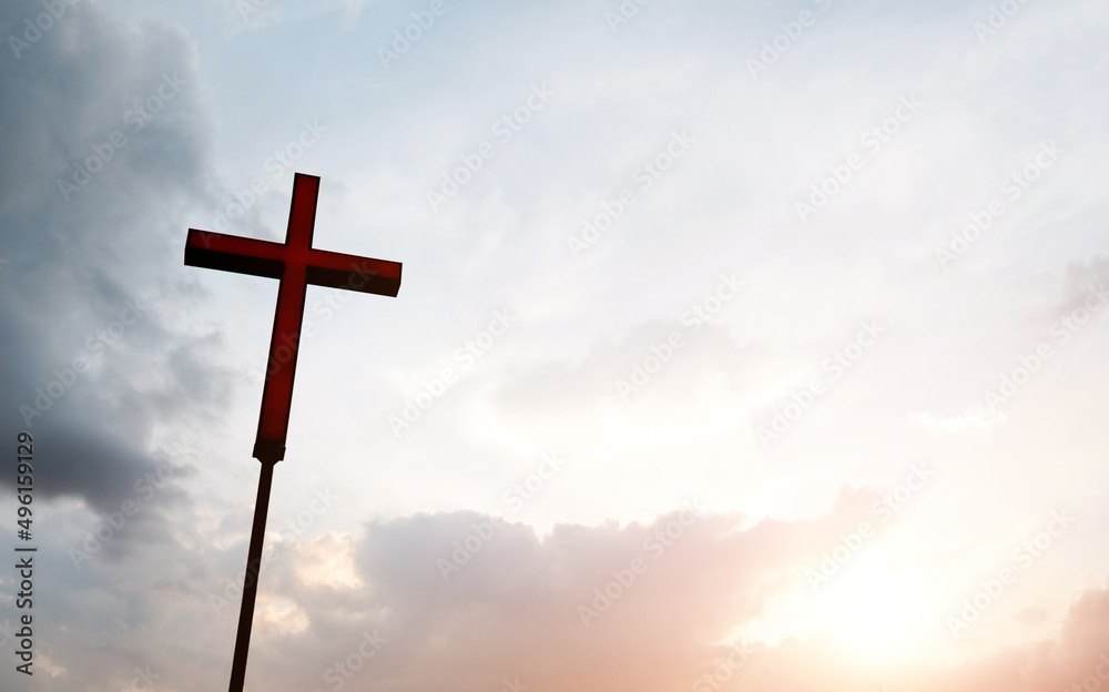 A christian cross under cloudy sky A christian cross under cloudy sky