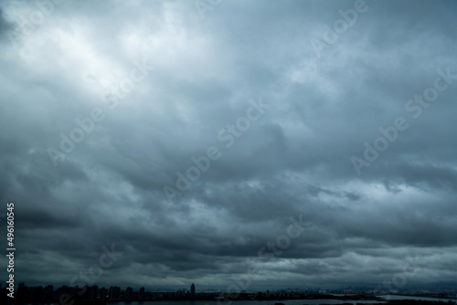 Dark clouds over a city by the sea